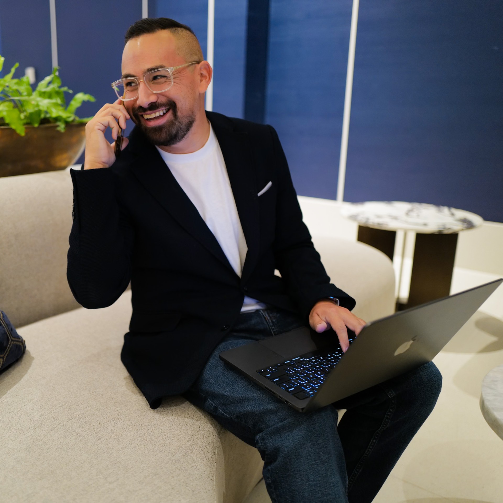 Ryan Salinas laughing while working on a laptop